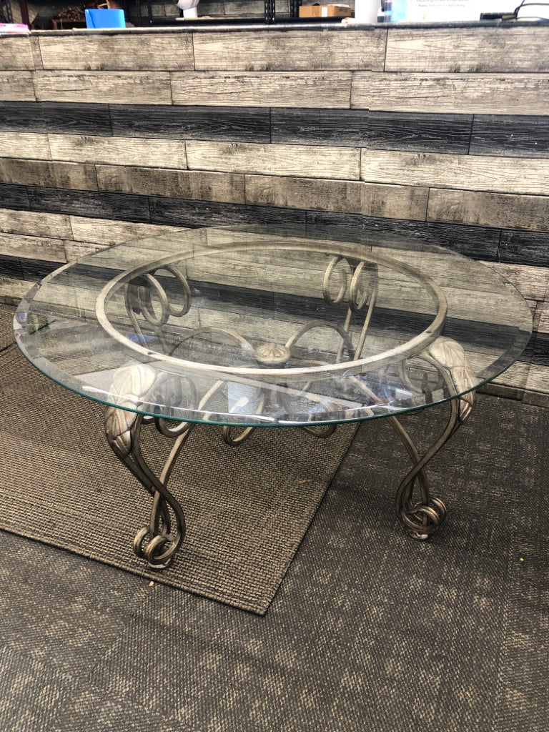 GLASS CIRCLE COFFEE TABLE W/ DISTRESSED SLIVER BASE/LEGS.