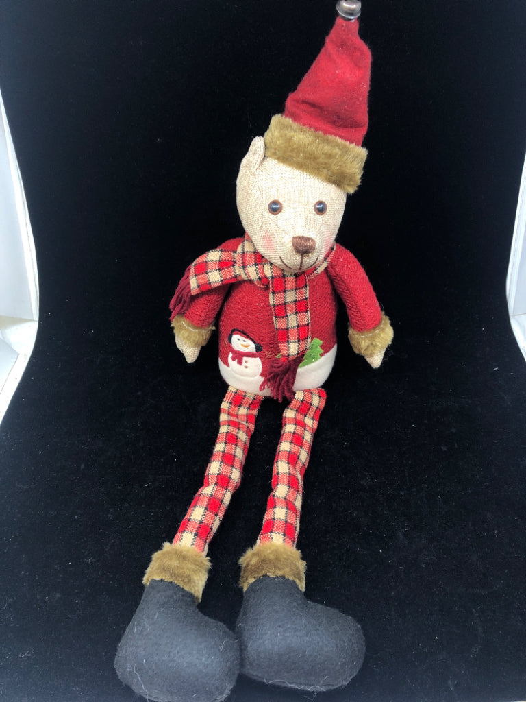 SHELF SITTING TEDDY IN RED COAT.
