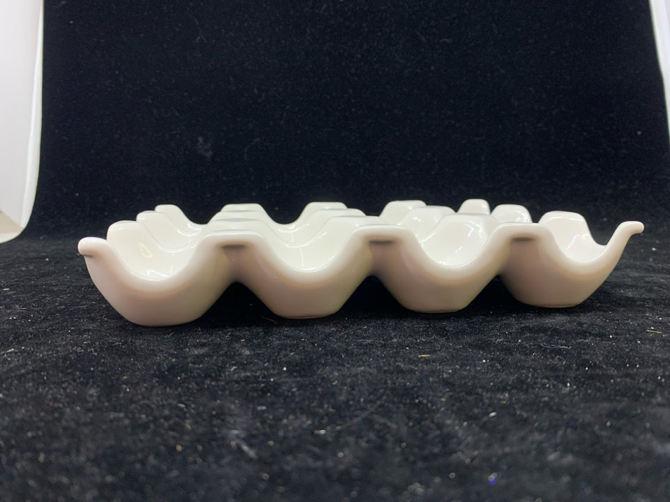 WHITE CERAMIC EGG HOLDER.