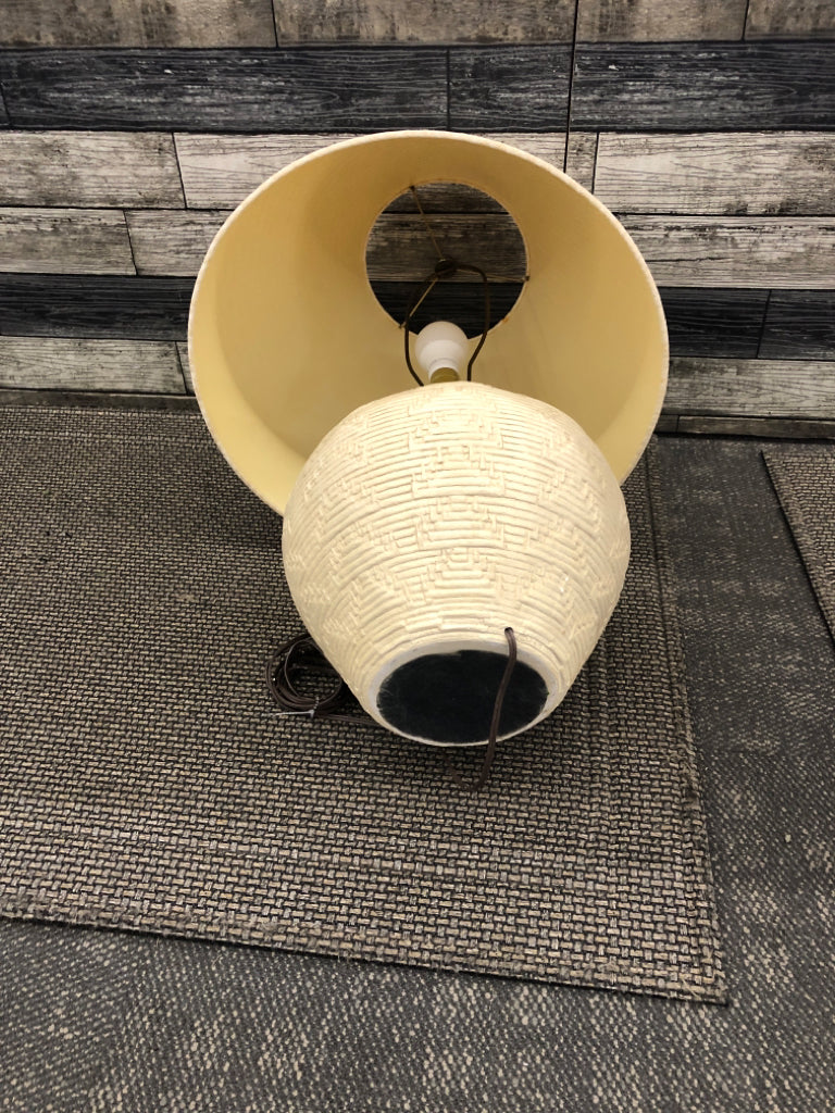 CREAM AZTEC LAMP W TAN SHADE.