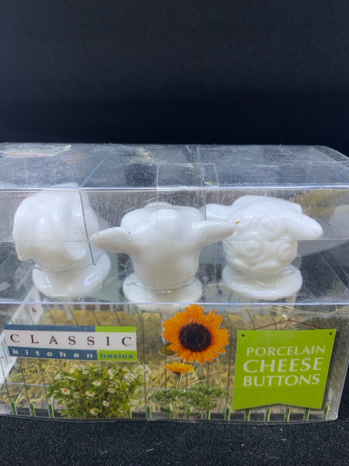 NIB COW PORCELAIN CHEESE BUTTONS.