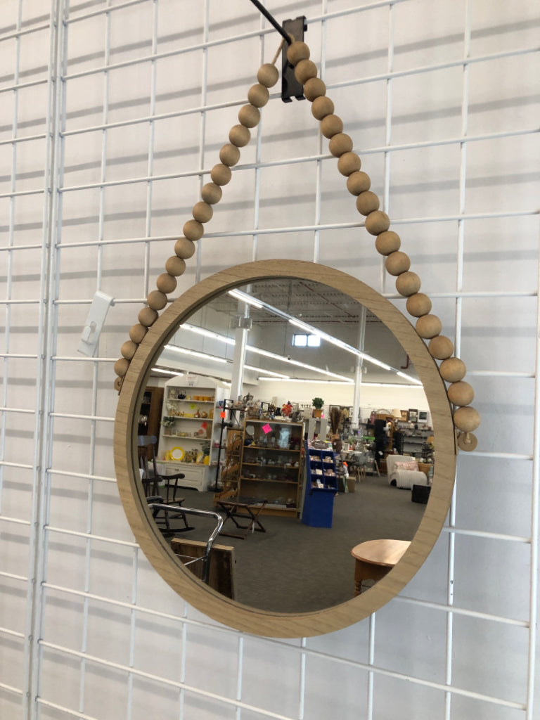 ROUND WOOD WALL MIRROR ON WOOD BEAD GARLAND.
