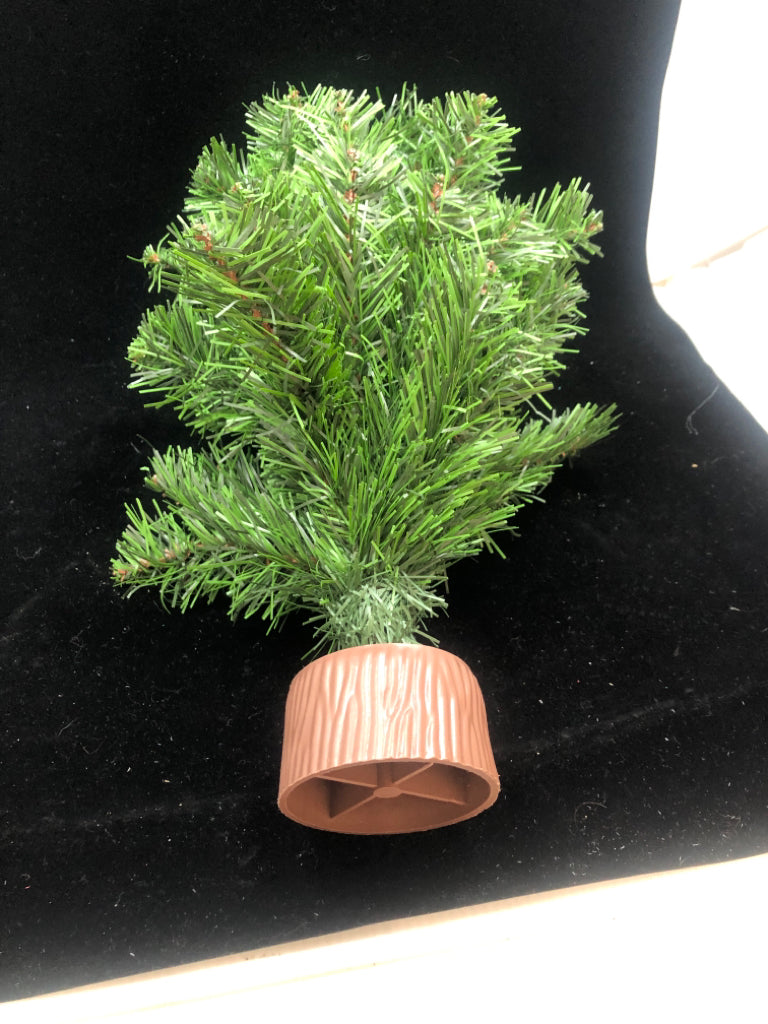 TABLETOP ARTIFICIAL PINE TREE ON BROWN BLOCK.