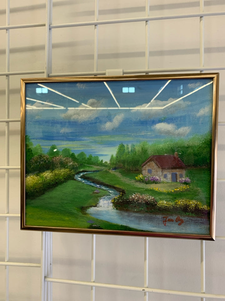 SMALL PAINTED OF COTTAGE W/ SMALL RIVER BLUE SKIES.