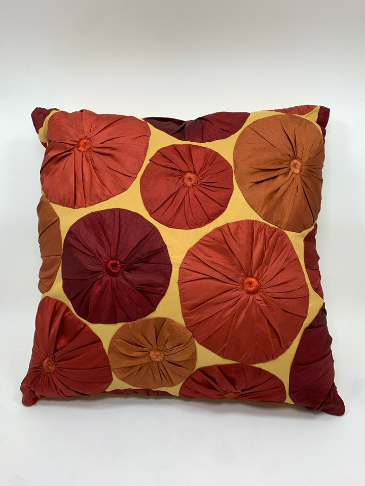 YELLOW W/RED PLEATED CIRCLES PILLOW.