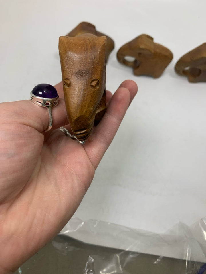 4 WOOD CARVED ELEPHANT NAPKIN RINGS IN BAG.