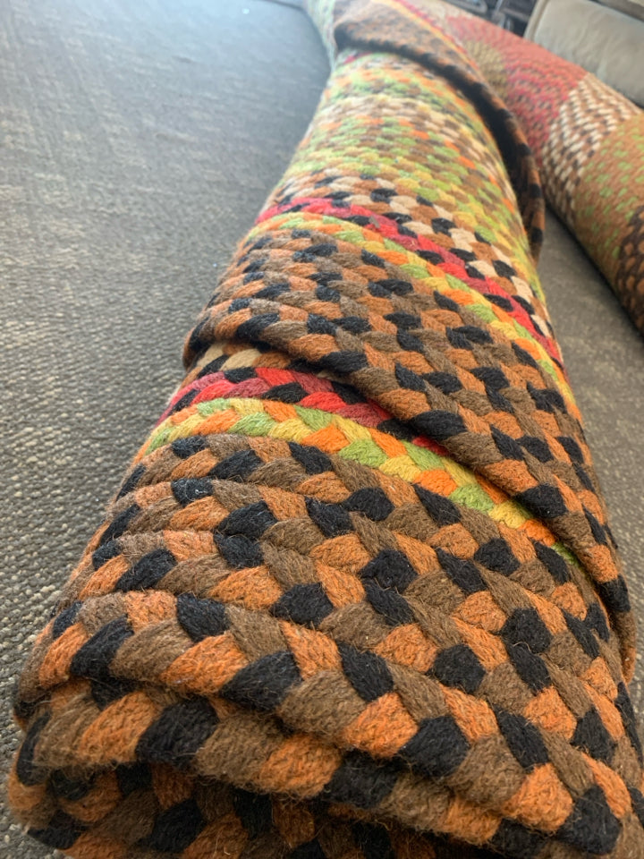 BROWN, RED, GREEN OVAL BRAIDED RUG.