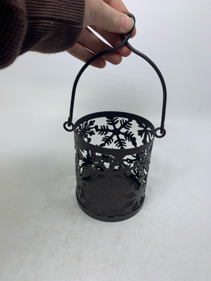 BROWN METAL SNOWFLAKE CANDLE HOLDER.