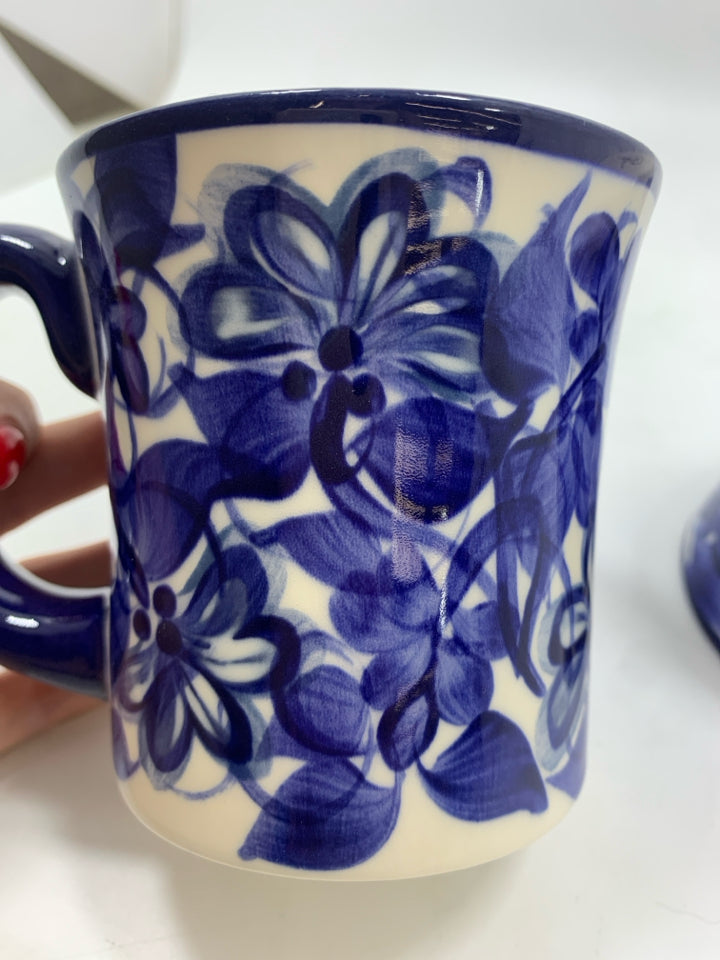 2 NAVY FLORAL PAINTED MUGS.