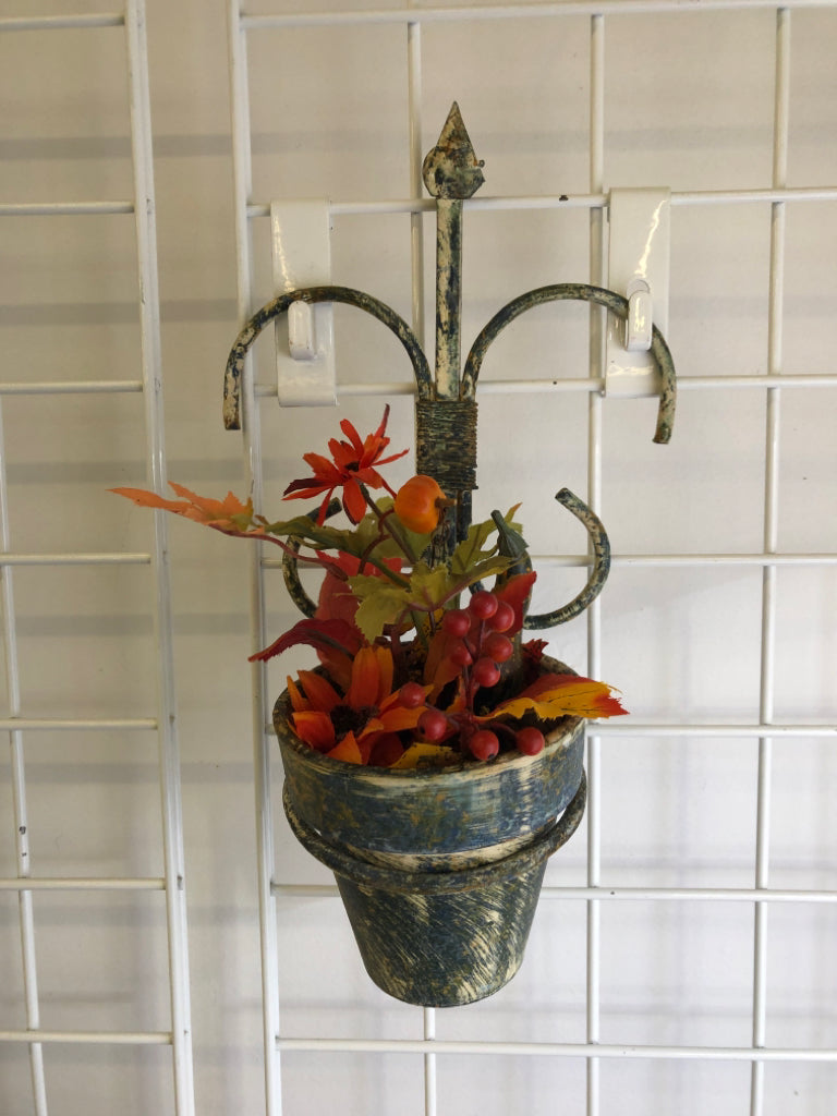 FAUX AUTUMN PLANTER IN RUSTIC METAL WALL HANGING.