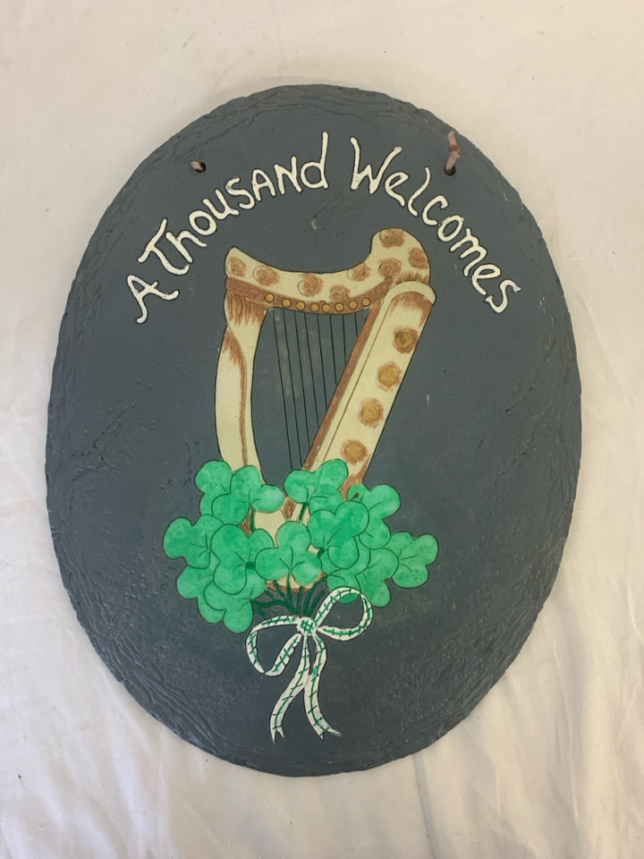 A THOUSANDS WELCOMES HARP OVAL WALL HANGING.