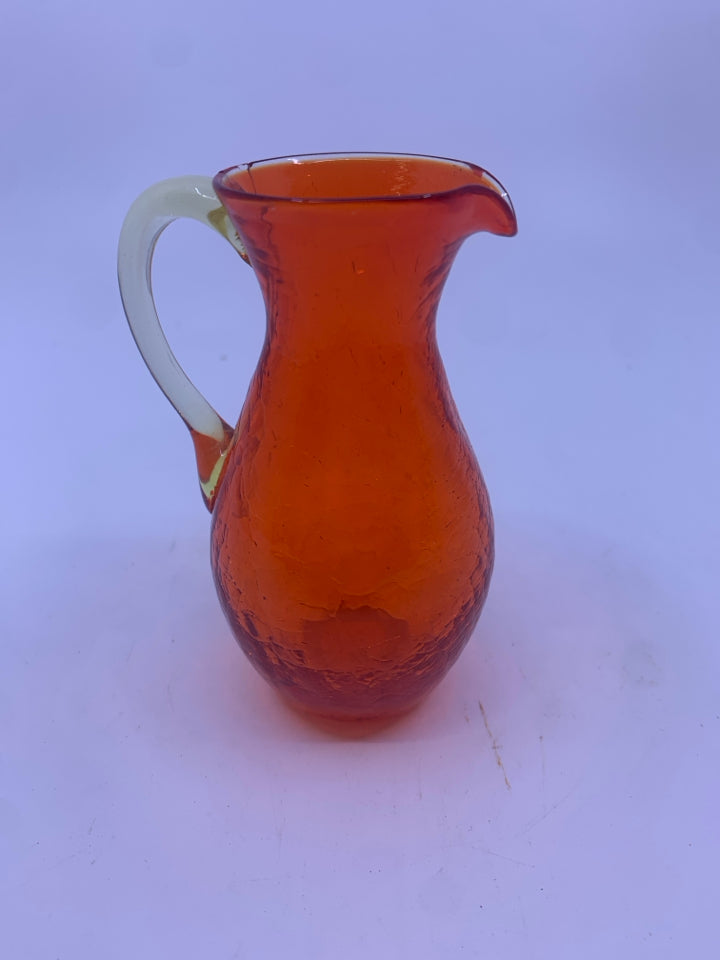 SMALL ORANGE CRACKLE GLASS FLARED TOP PITCHER.