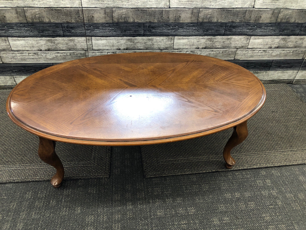 DARK WOOD OVAL COFFEE TABLE.