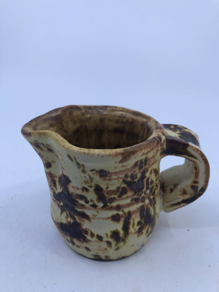 BROWN AND YELLOW COW PATTERN CREAMER.