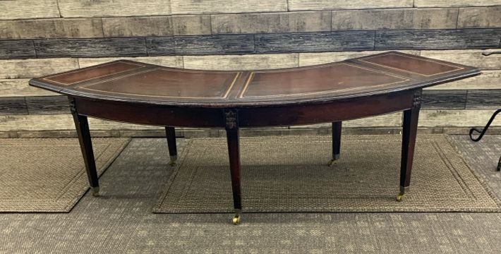 VTG DARK WOOD CRESCENT SHAPE COFFEE TABLE ON WHEELS.