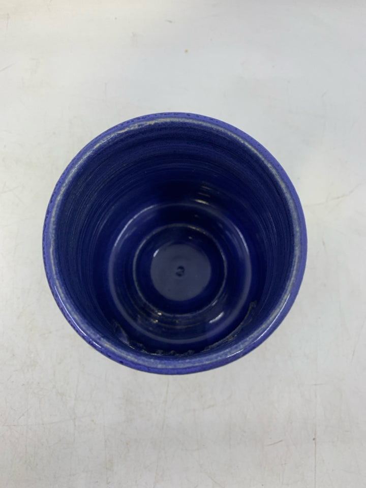 TEXTURED TAN POTTERY TEA LIGHT W/ MOTHER MARY/JOSEPH CUT OUT BLUE INSIDE.