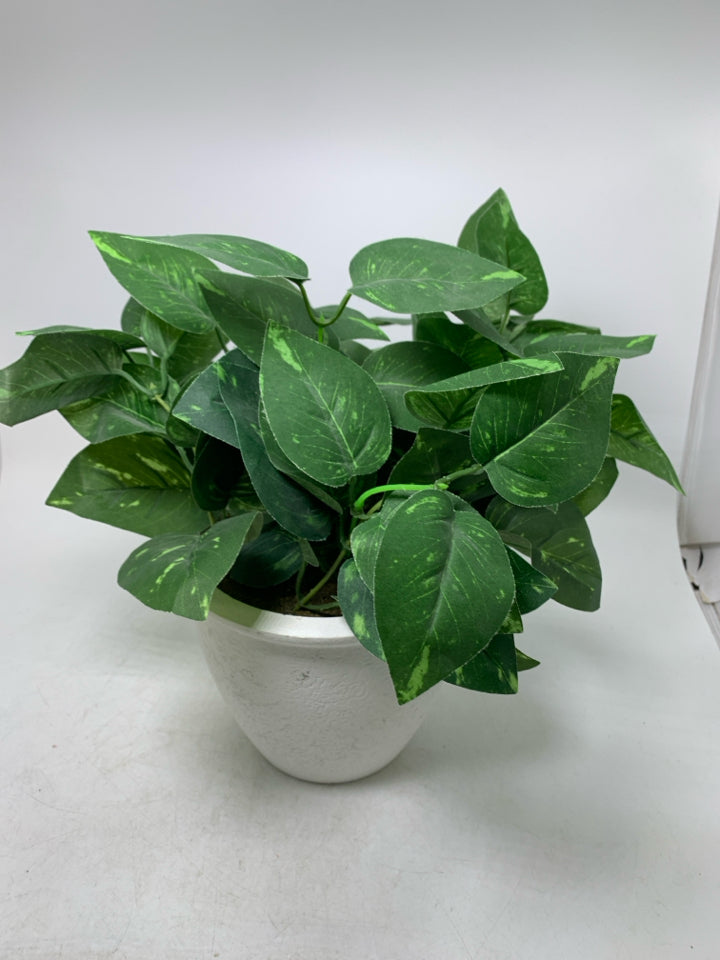 WHITE PLANTER W/ FAUX LEAVES.
