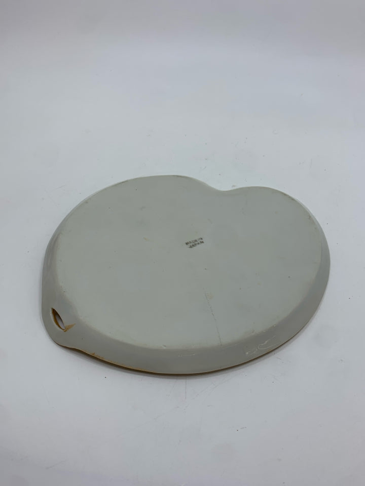 LAVENDER CANDLE CUP ON PEACH IRIDESCENT TRAY.
