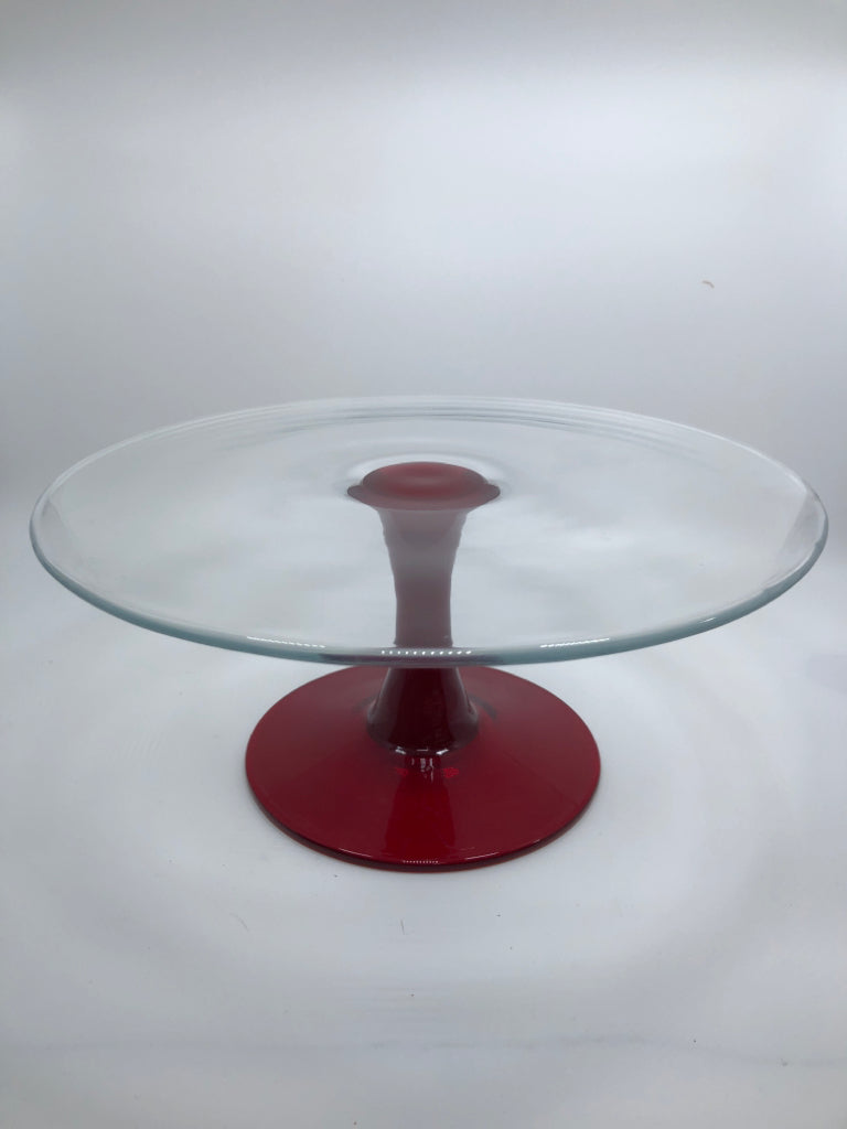 FOOTED GLASS CAKE STAND W/RED GLASS BASE.