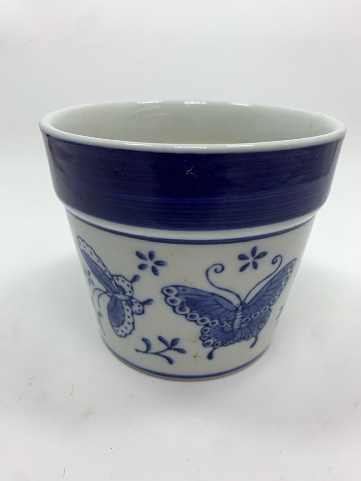 BLUE BUTTERFLIES ON WHITE PLANTER.