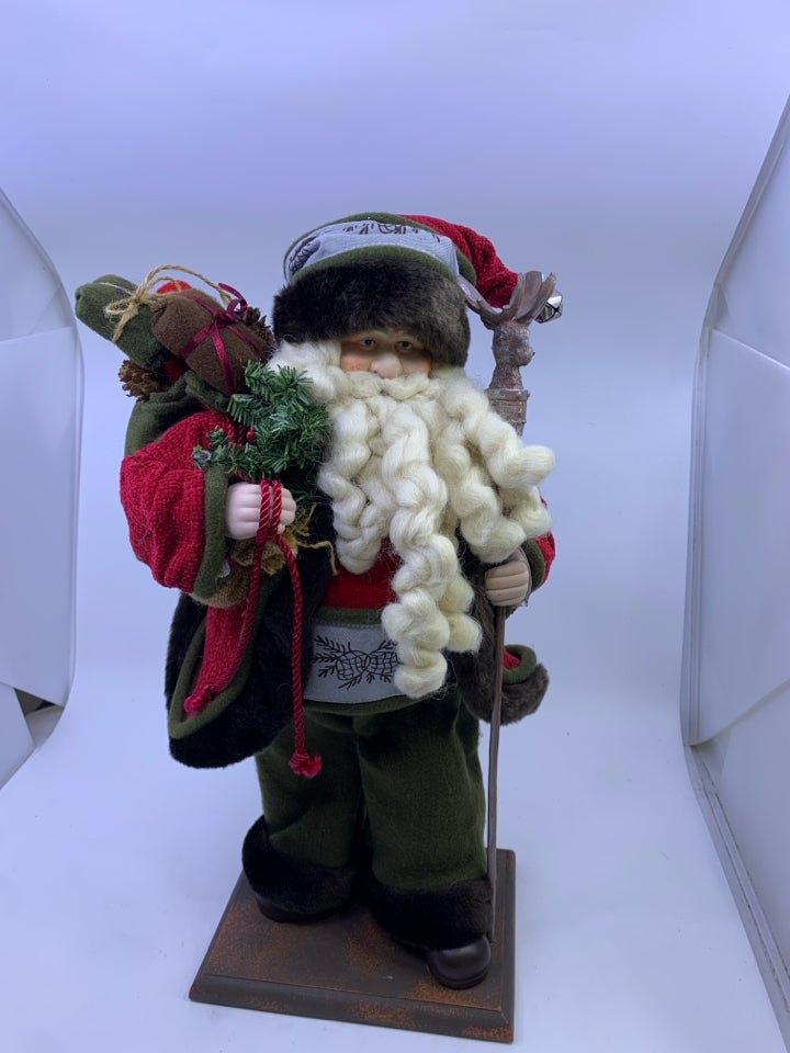 GREEN SANTA WITH DEER POLE HOLDING SACK.