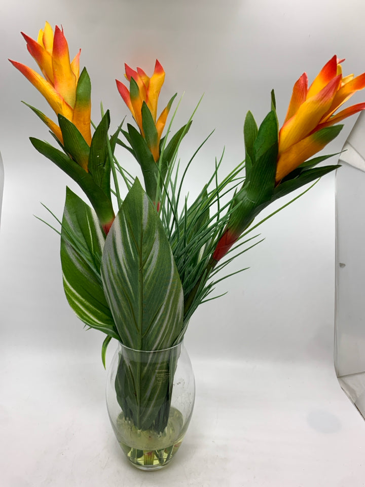 FAUX TROPICAL FLOWER IN CLEAR VASE.