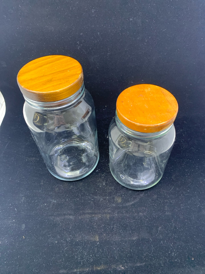 2 GLASS WOOD TOP CANISTERS.