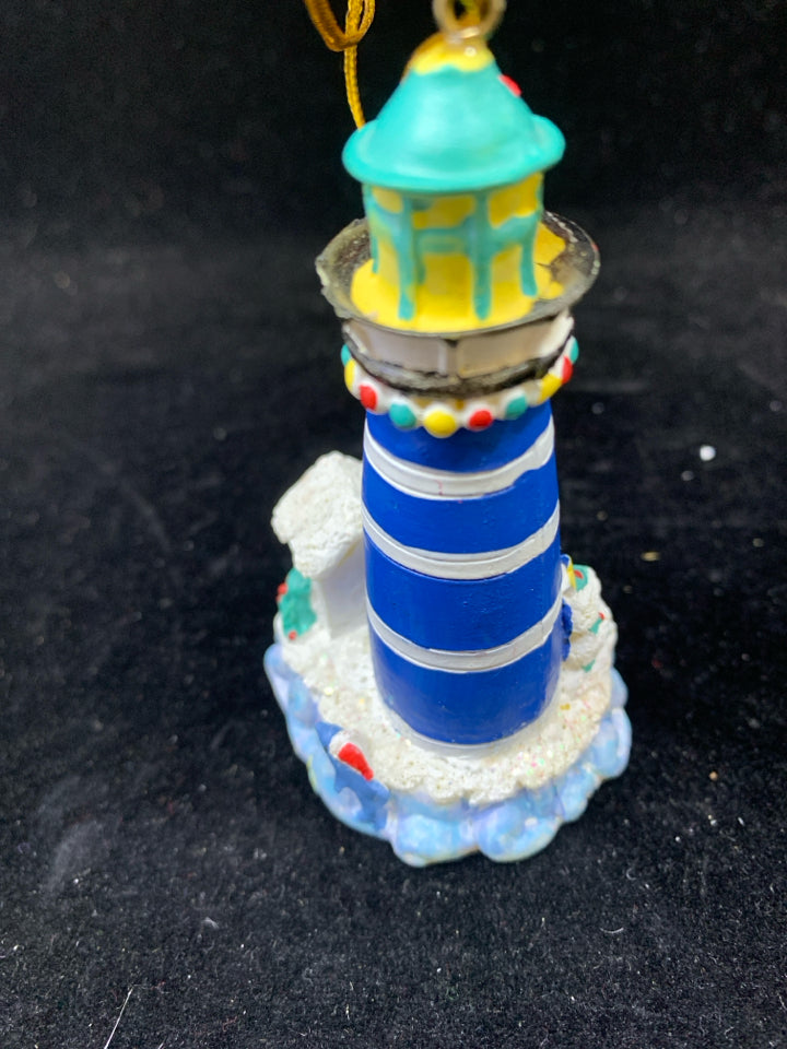 BLUE LIGHTHOUSE ORNAMENT W/SPYING SANTA.