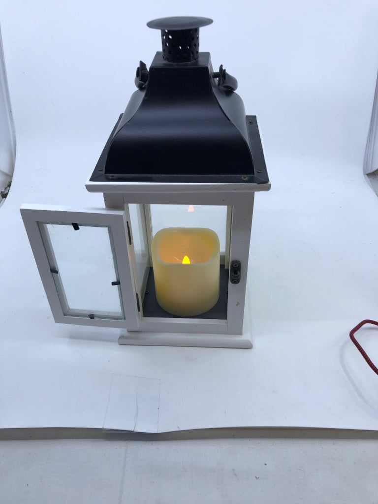 WHITE/BLACK LANTERN WITH FLICKERING CANDLE.