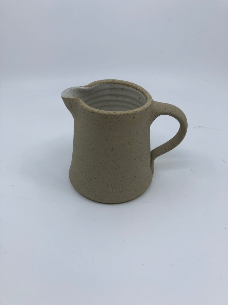 POTTERY PITCHER ROUGH OUTSIDE W/ WHITE GLAZE INSIDE HERITAGE COLLECTION.