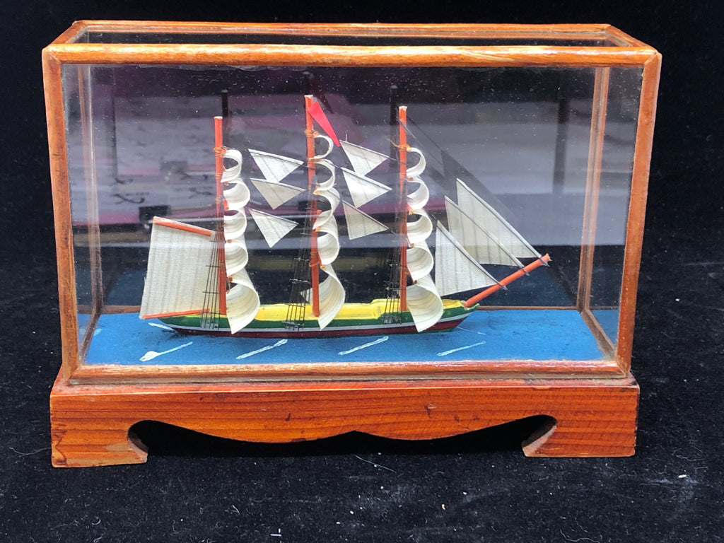 SMALL SHIP IN GLASS CASE.