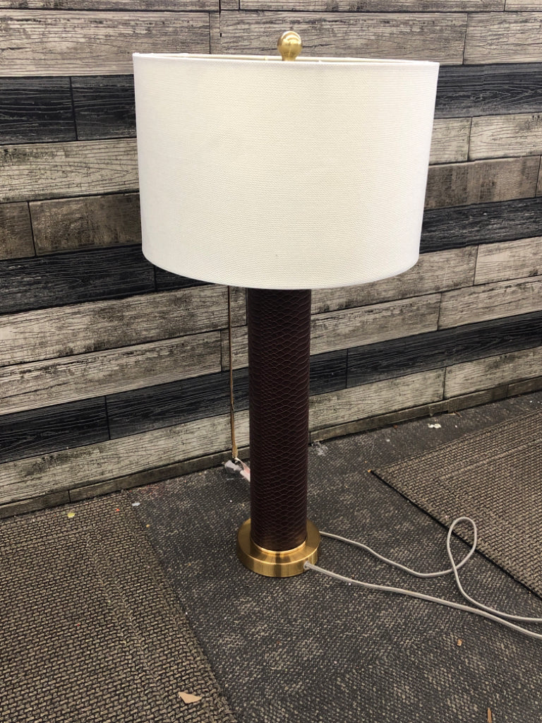 FAUX LEATHER GOLD BASE LAMP W/TAN SHADE.