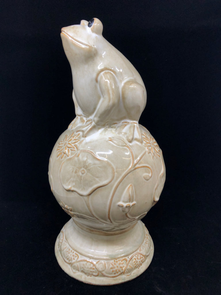 CREAM CERAMIC FROG ON SPHERE W/FLOWER DESIGN.