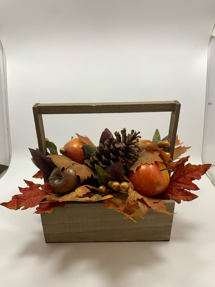 FAUX FALL FOLIAGE AND APPLES IN WOODEN BASKET.