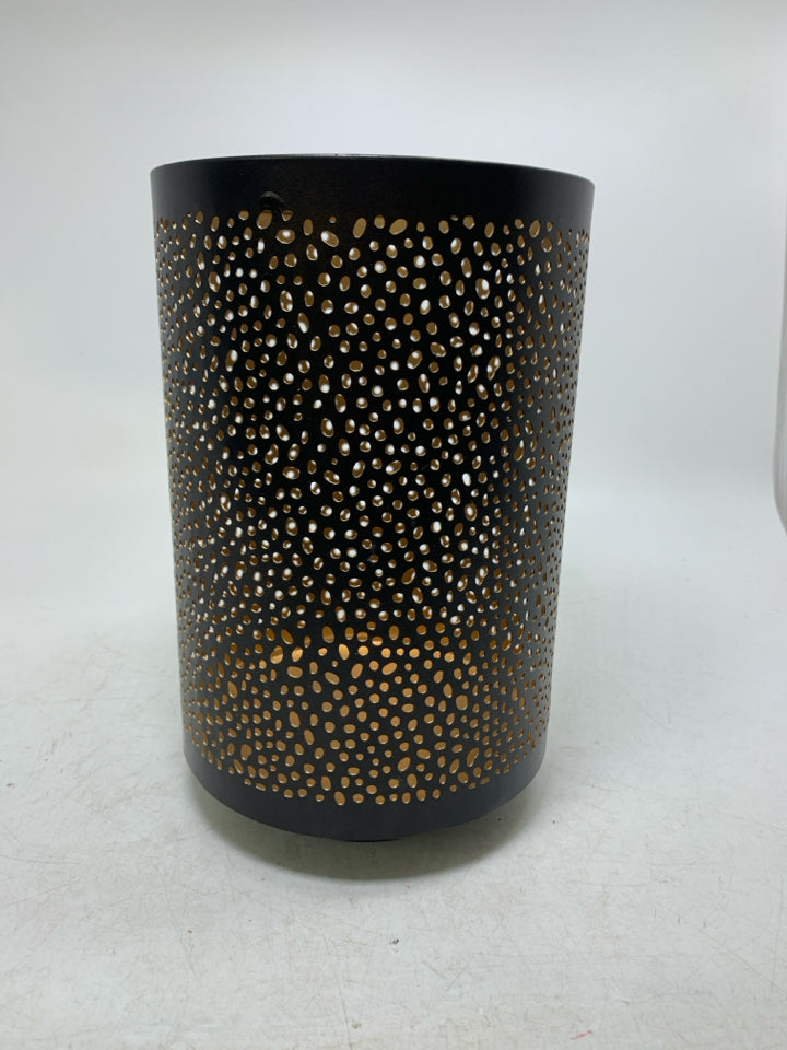 FOOTED METAL PIERCED PILLAR CANDLE HOLDER.