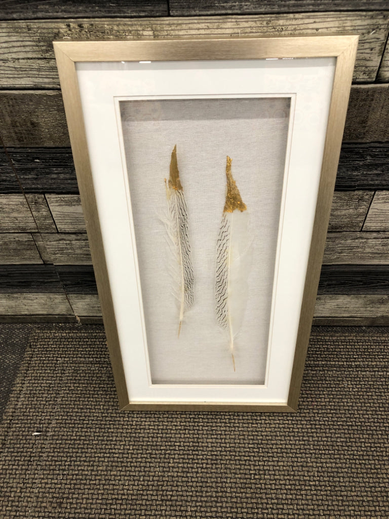 2 FEATHERS W GOLD TIPS SHADOW BOX IN GOLD FRAME.