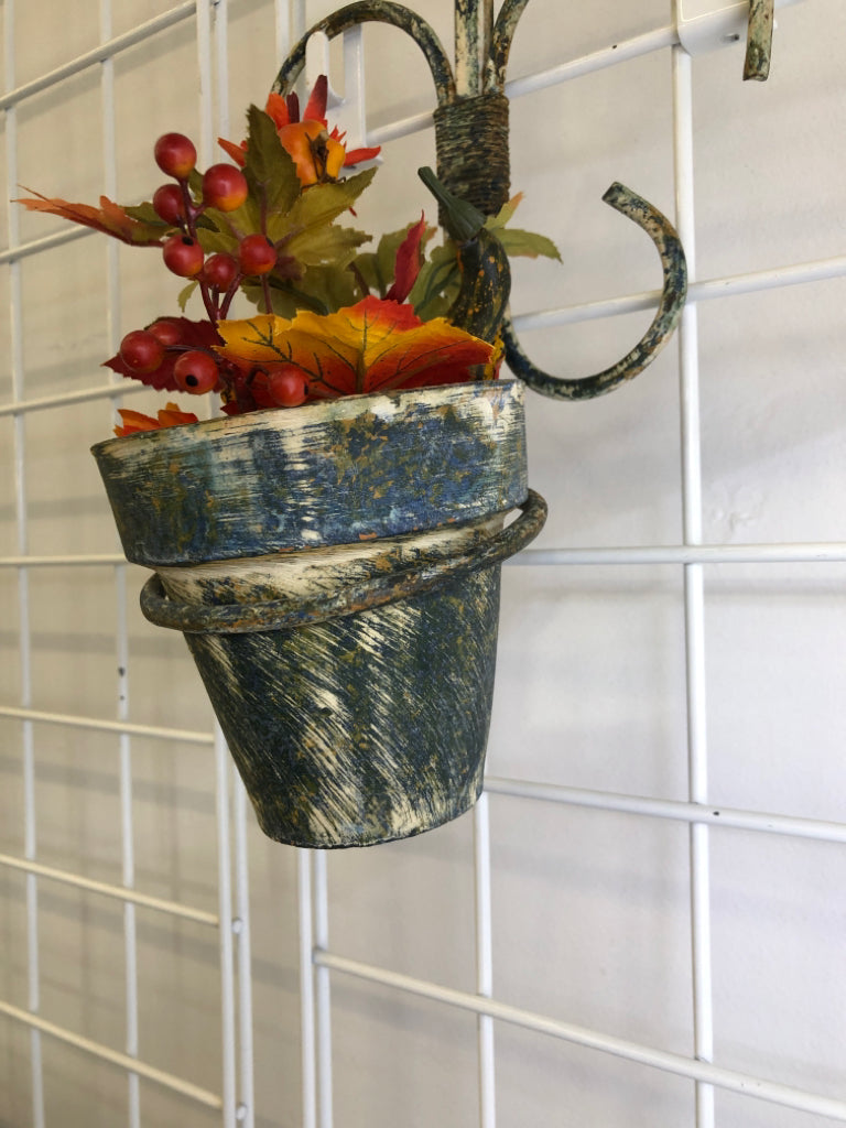 FAUX AUTUMN PLANTER IN RUSTIC METAL WALL HANGING.