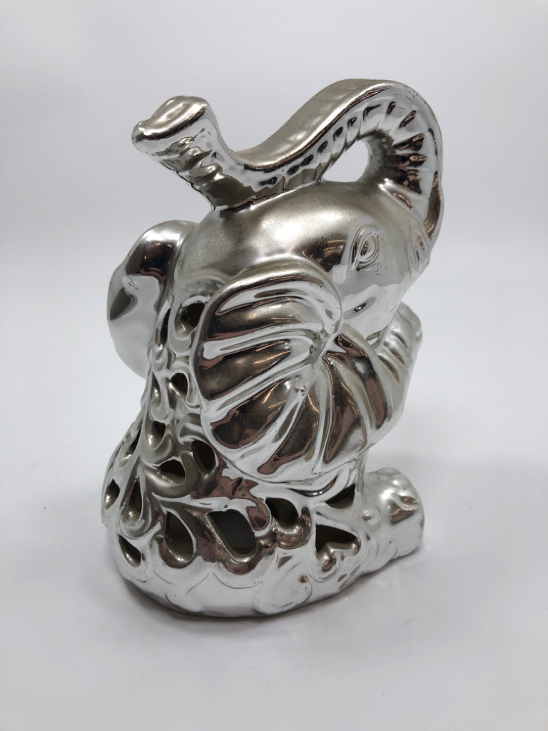 SILVER COLOR CERAMIC SITTING ELEPHANT.
