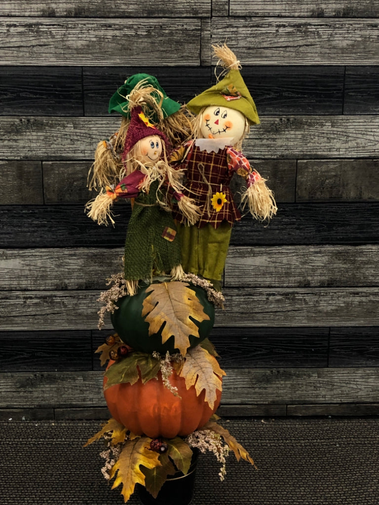 PUMPKIN AND SCARECROW STACK W/LEAVES.