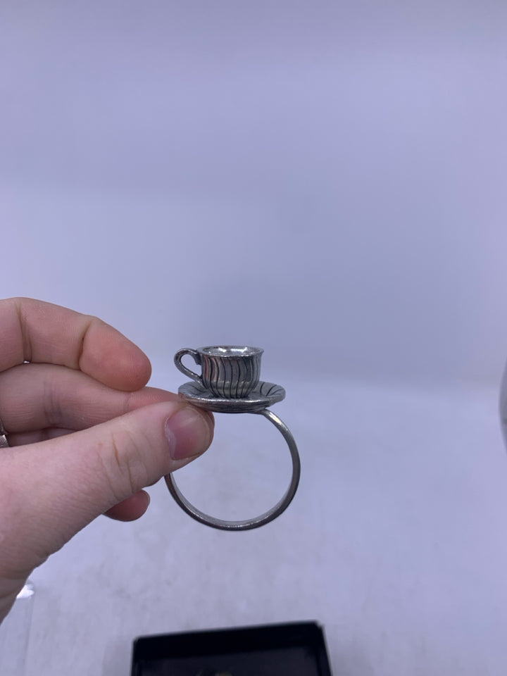 IN BOX 4 PEWTER TEACUP NAPKIN RINGS.