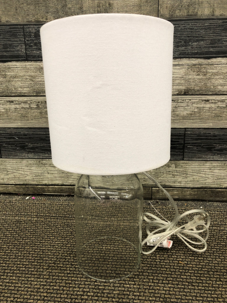 CLEAR GLASS LAMP W/WHITE SHADE.