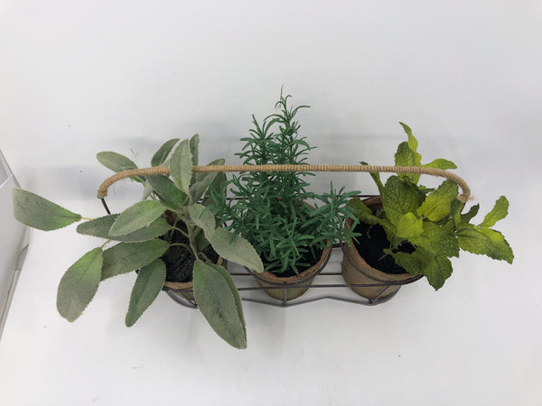 3 FAUX PLANTS IN BROWN METAL HOLDER.