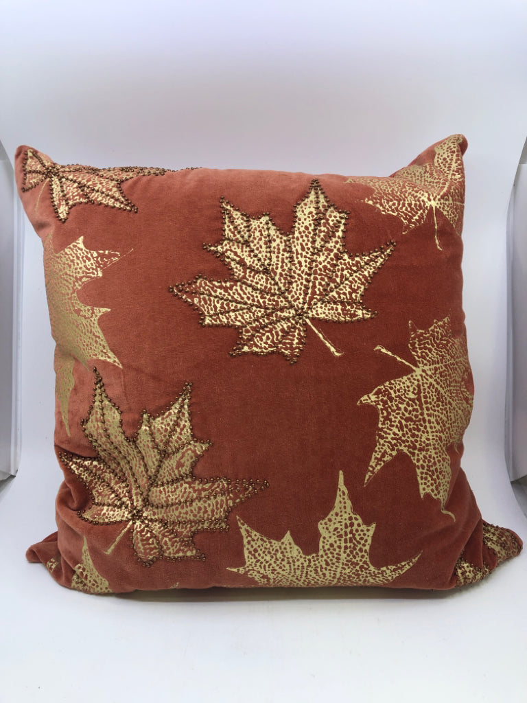 RUST COLORED PILLOW W/ BEADED GOLD MAPLE LEAVES.