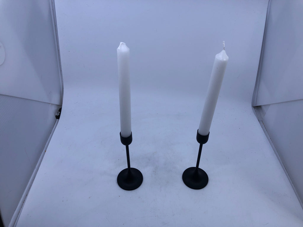 2 BLACK TAPER CANDLE HOLDER WITH WHITE CANDLES.