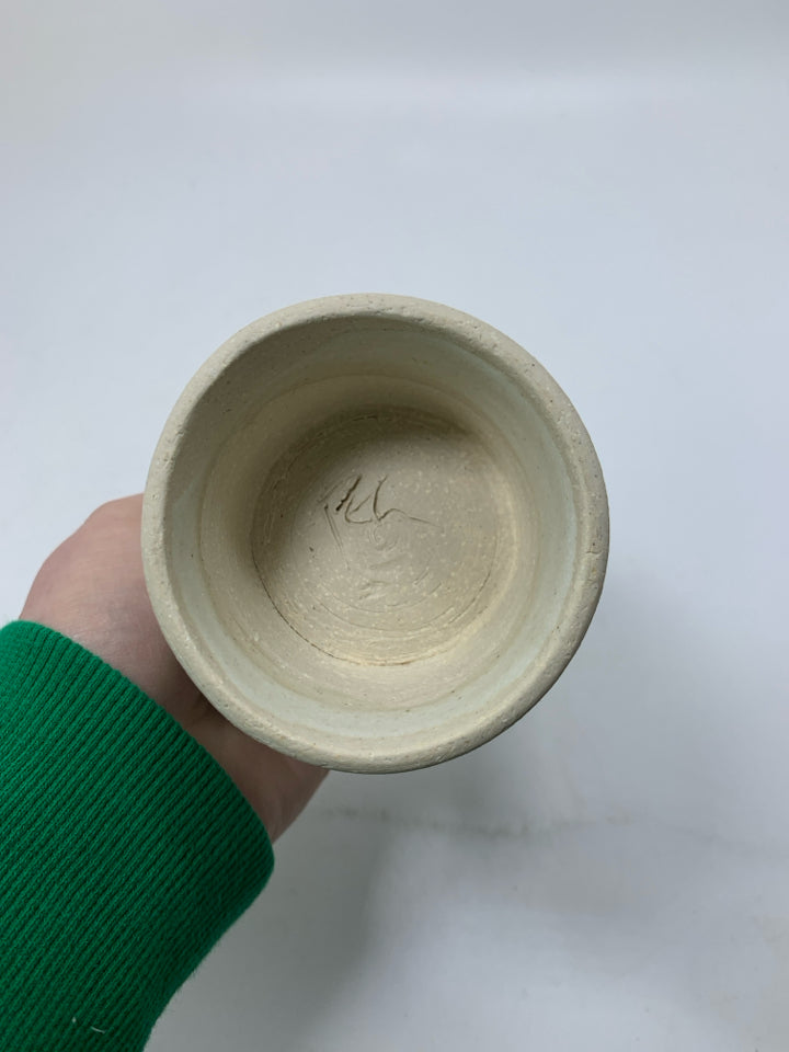 CREAM POTTERY IMPERFECT FOOTED CUP.