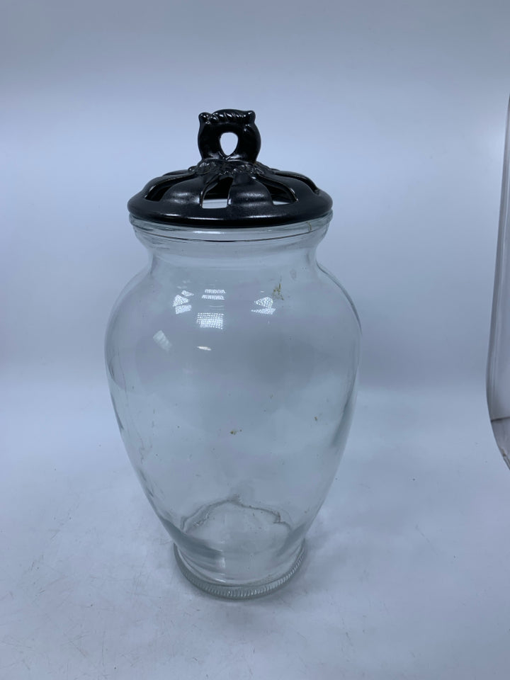 LARGE GLASS VASE WITH BLACK PIERCED LID.