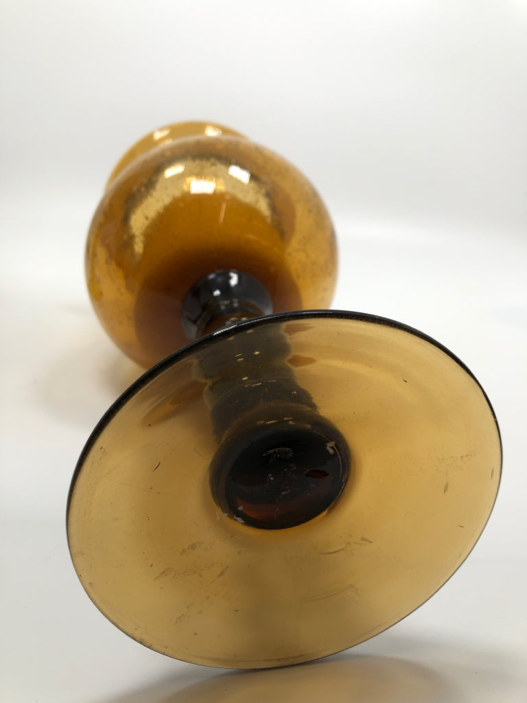 2 AMBER GLASS CANDLE HOLDERS W/WAX CANDLES.