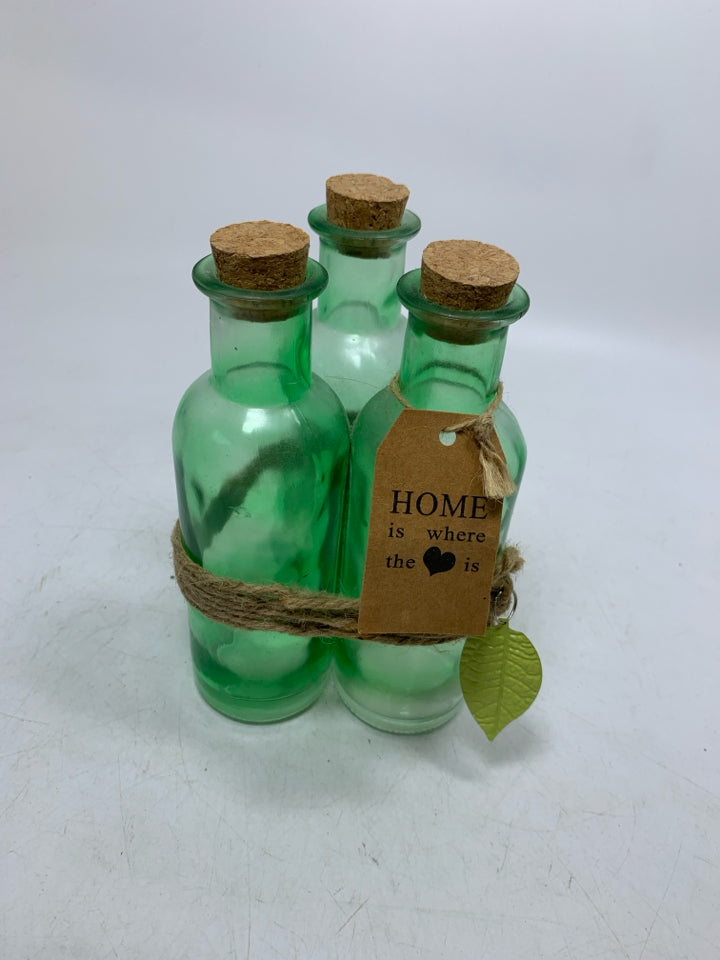 3 GREEN BOTTLE WRAPPED TOGETHER W/ CORK TOPS.