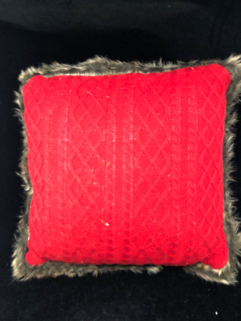 RED SWEATER PILLOW W/ FAUX FUR EDGE.