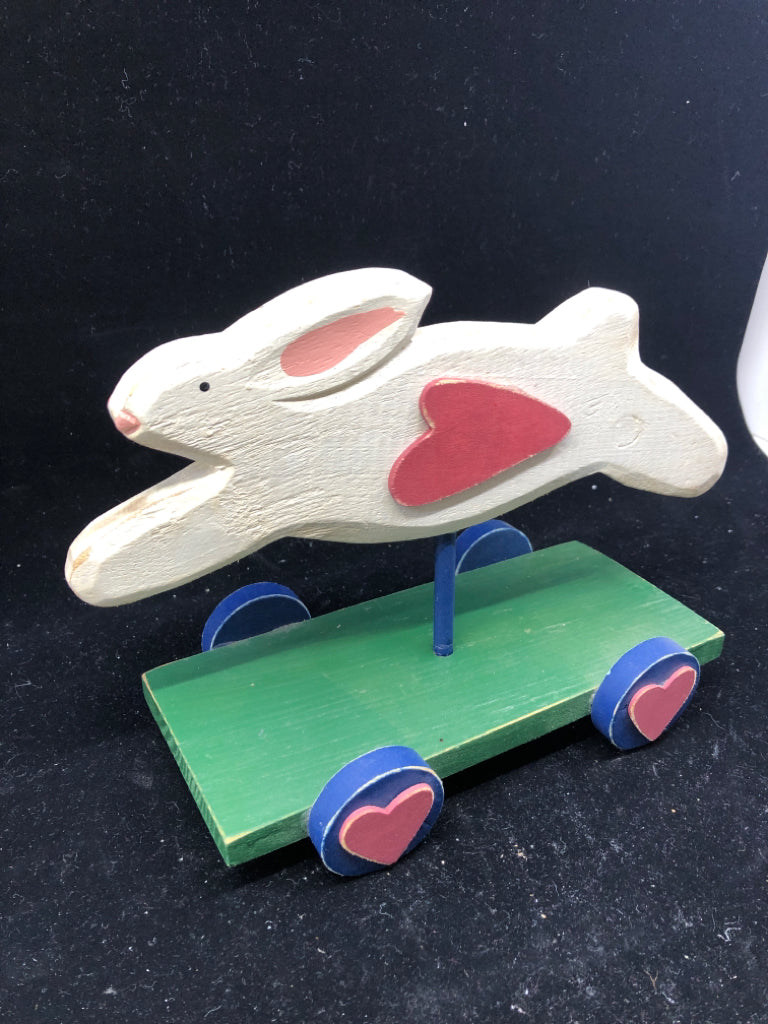 PRIMITIVE WHITE BUNNY ON GREEN CART.